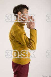 Arm flexing reference of yellow sweater red trousers Sidney 0015